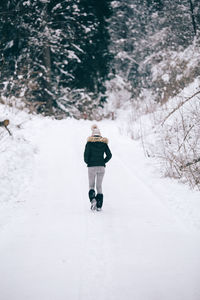 Man on snow covered road