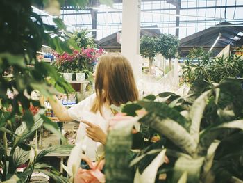 Woman standing in greenhouse