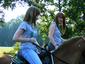 Women sitting on woman riding motorcycle