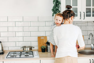 Rear view of couple standing at home