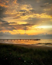 Scenic view of beach against sky during sunset