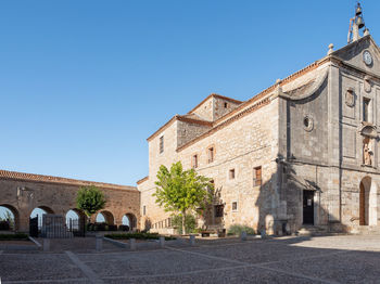 Low angle view of historic building against clear blue sky