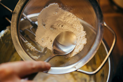 Close-up of hand holding bowl