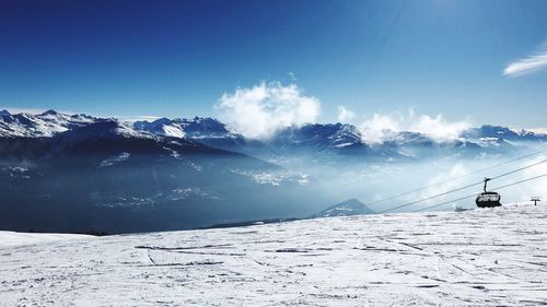 Scenic view of snow covered mountains against sky