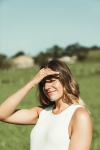 Portrait of a smiling young woman lying on field