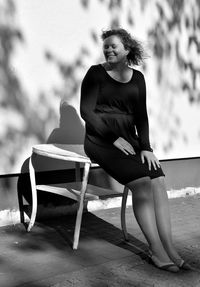 Woman sitting on table on street