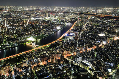 High angle view of illuminated city buildings at night