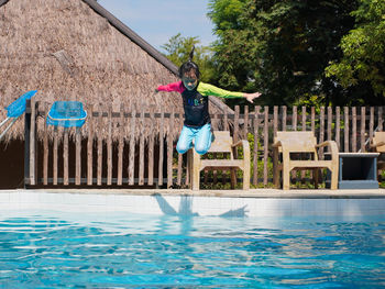 Full length of woman walking on swimming pool