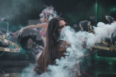 Portrait of young man smoking in car