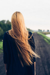 Rear view of woman looking at camera