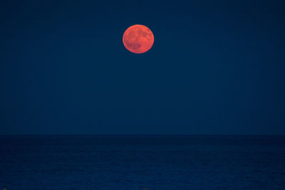 Scenic view of sea against clear sky at night