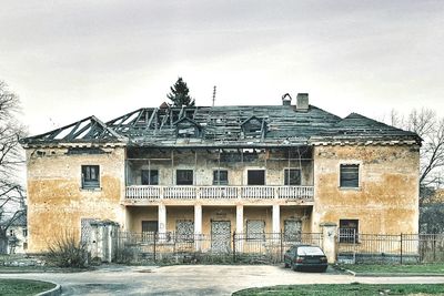 Abandoned car against sky