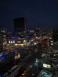 High angle view of illuminated city street and buildings at night