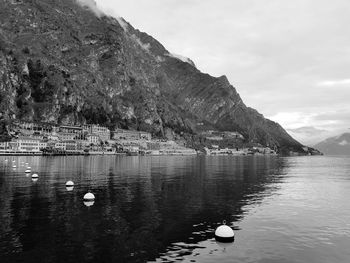 Scenic view of sea by mountains against sky