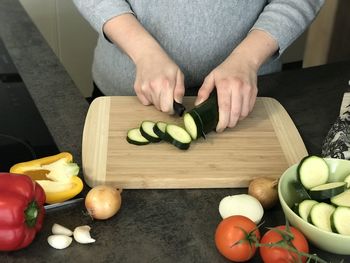 High angle view of man with vegetables on cutting board