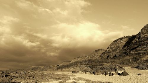 Scenic view of mountains against cloudy sky