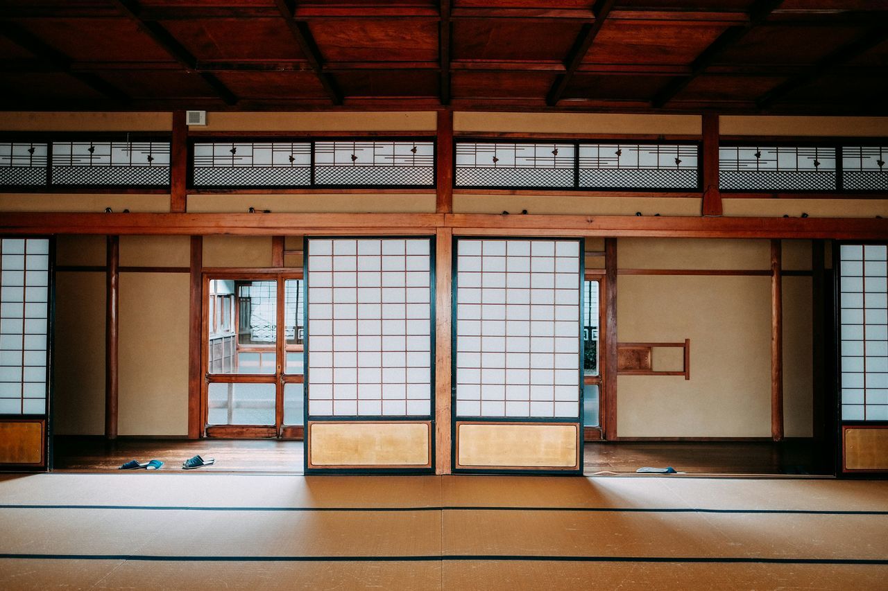 indoors, architecture, built structure, railroad station, text, empty, transportation, railroad station platform, absence, communication, western script, window, public transportation, door, ceiling, interior, flooring, no people, day, graffiti