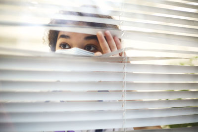 Low angle view of woman looking through window