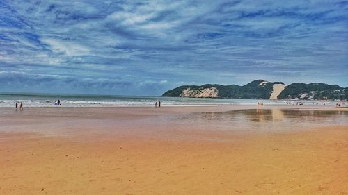 View of beach against cloudy sky