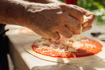 Cropped image of hand holding food