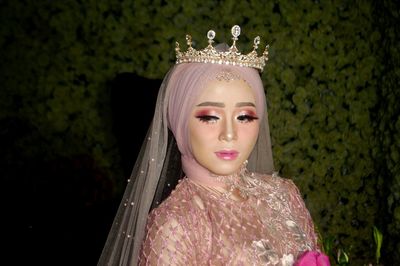 Bride with make-up looking away against plants