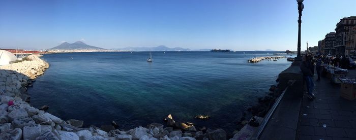 Panoramic view of sea against blue sky