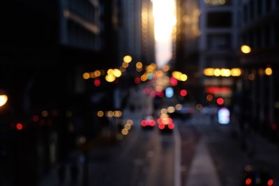 Defocused image of illuminated city street at night