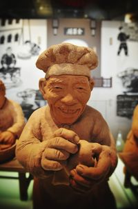 Close-up of man with statue