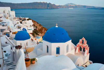 Famous view of santorini oia village with blue dome of greek orthodox christian church