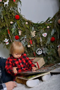 Rear view of woman holding christmas tree