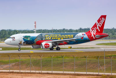 Airplane on airport runway against clear sky