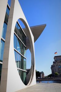 Low angle view of modern building against clear blue sky