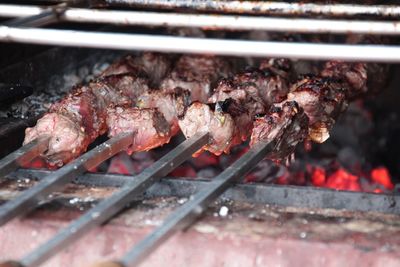 Skewers with meat on cooking on barbecue