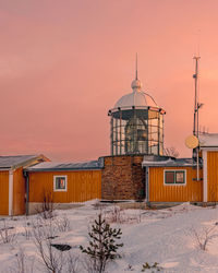 Built structures against sky during sunset