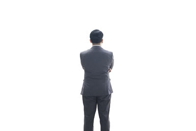 Rear view of man standing against white background