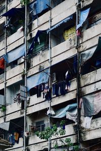 Low angle view of clothes hanging on old building