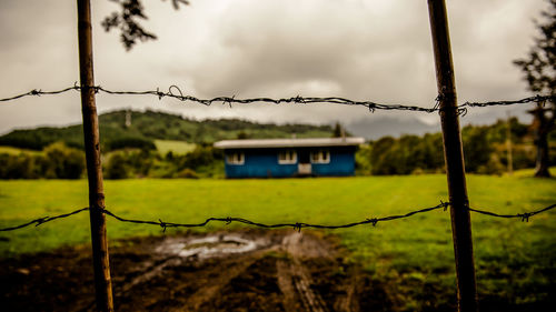 Close-up of barbed wire against sky