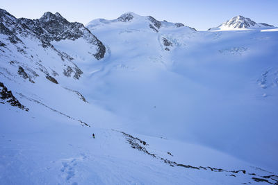 Scenic view of snow covered mountains against sky