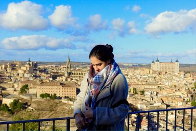 Woman standing against cityscape