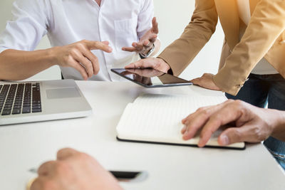 Low angle view of people working on table