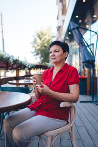 Smiling mature woman drinking coffee