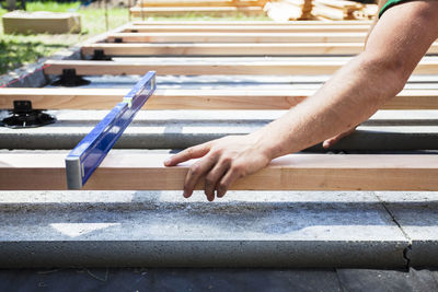 Cropped hand of man working at construction site