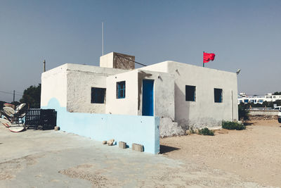 Built structure by building against clear blue sky