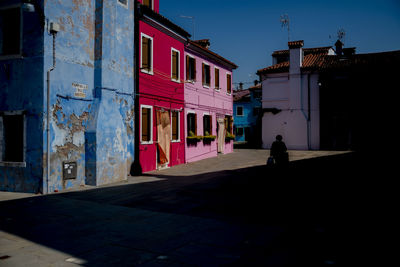 People walking on street against buildings in city