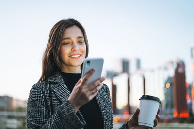 Portrait of young woman using mobile phone