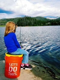 Portrait of girl fishing by lake