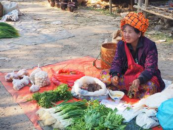 Woman looking away while sitting at market