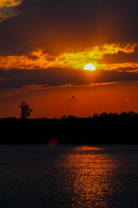 Scenic view of sea against romantic sky at sunset