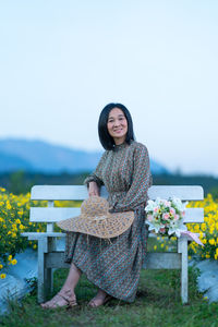 Portrait of smiling woman sitting on seat