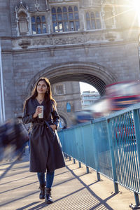 Full length of woman standing at tower bridge